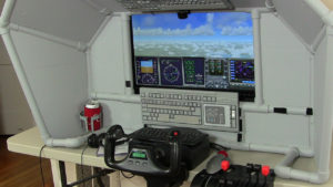 at the controls of this desktop home flight sim