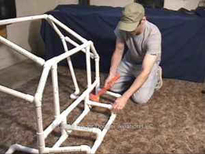 man building a pipe frame