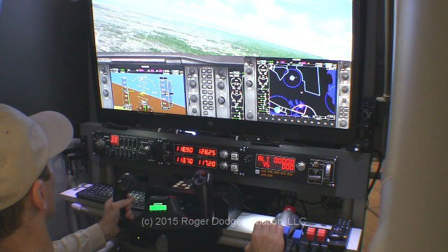 man at controls of a flight simulator pod